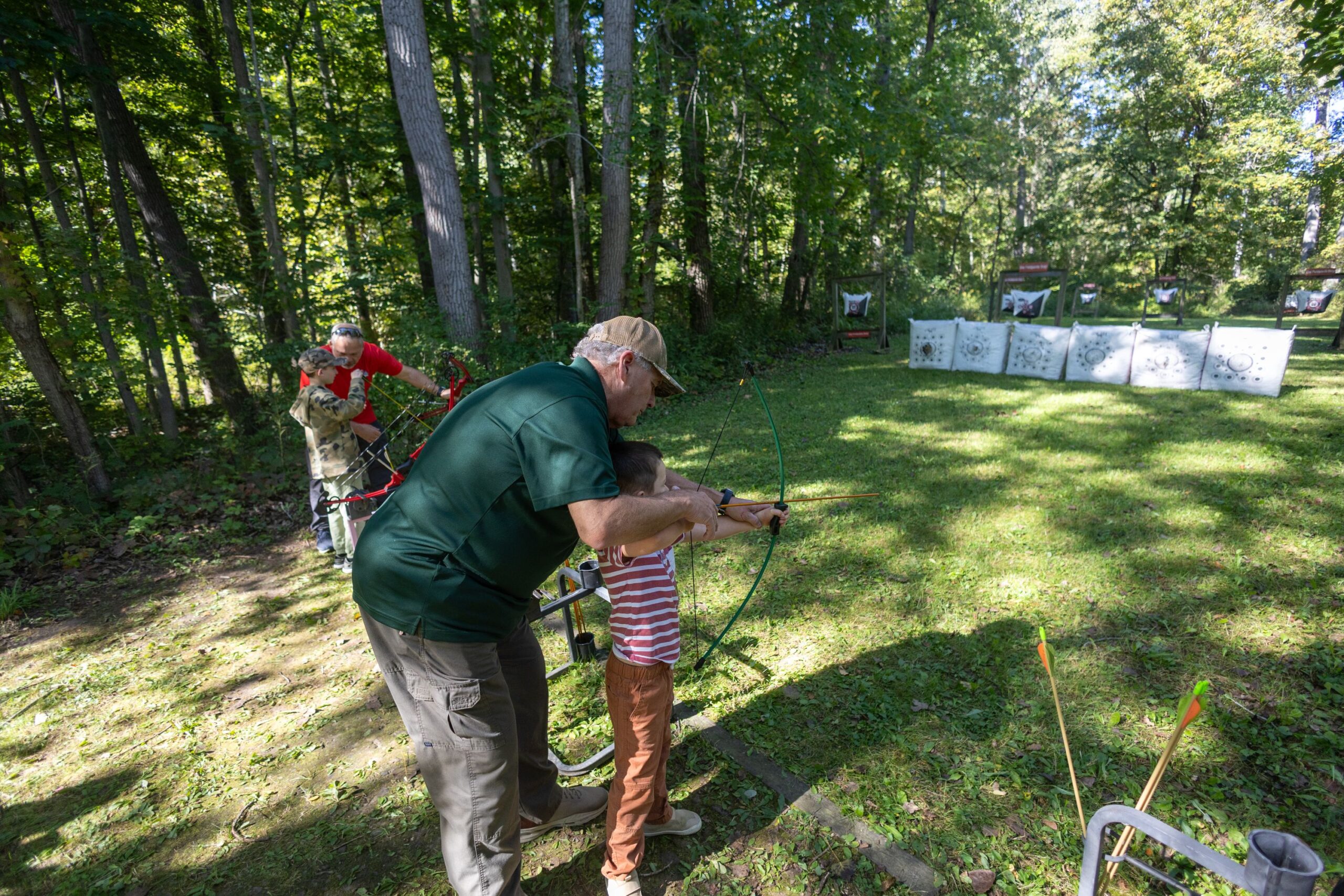 2026Sept26-056 ECFSC President and Hunter Instructor Jack Coad assists a new young archer.