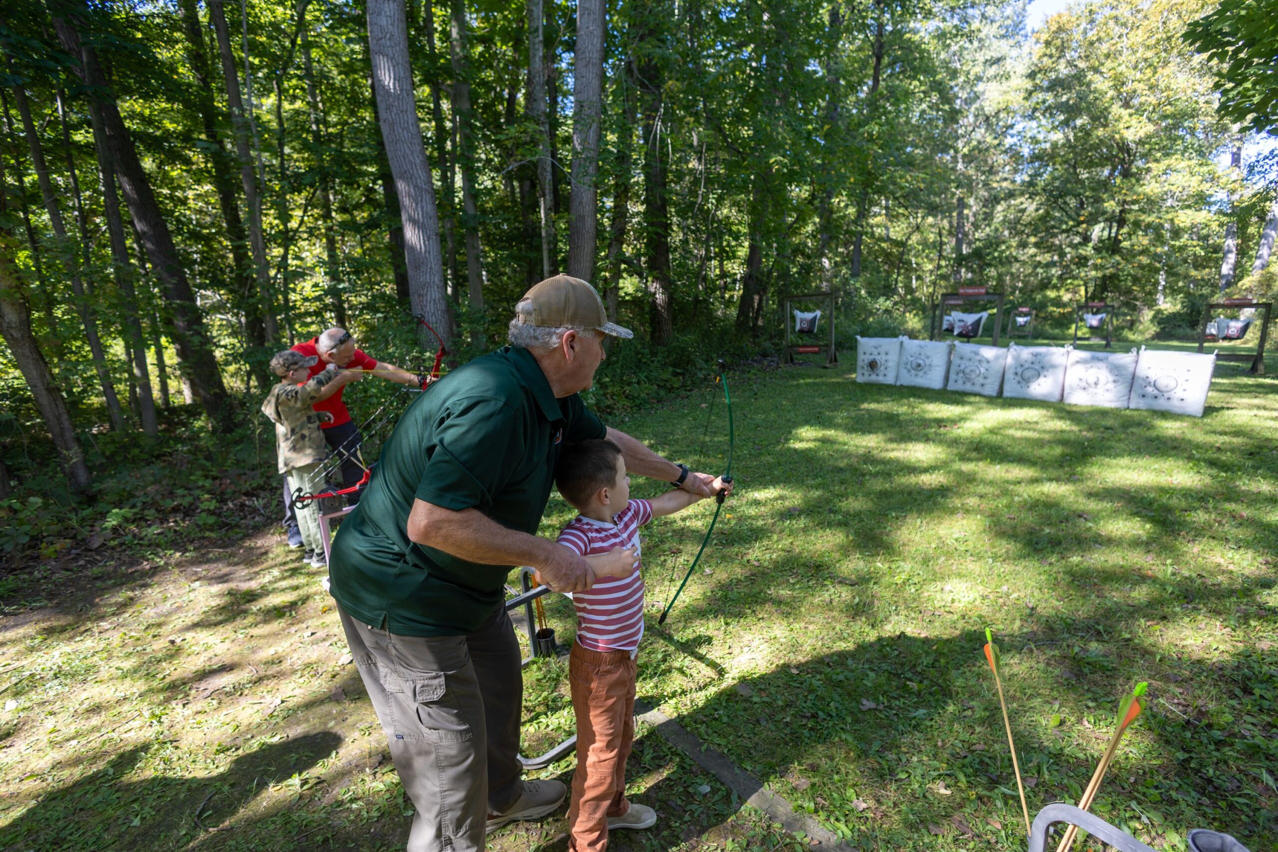 2026Sept26-057 ECFSC President and Hunter Instructor Jack Coad assists a new young archer.